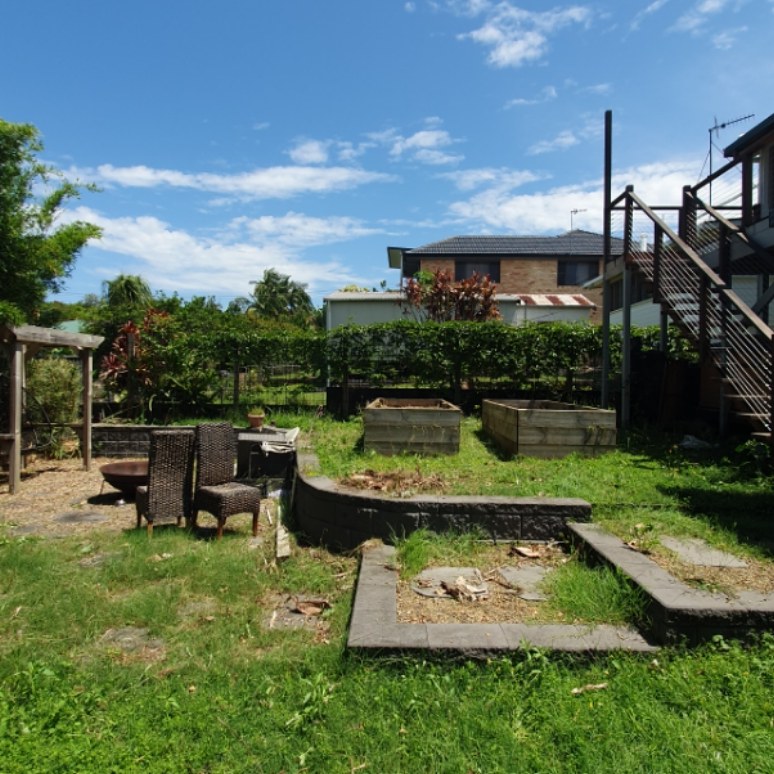 Backyard garden cleared around timber sleepers