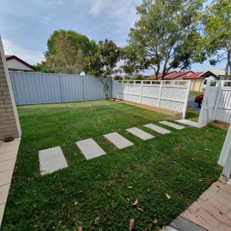 Freshly mown lawn with square stepping stones