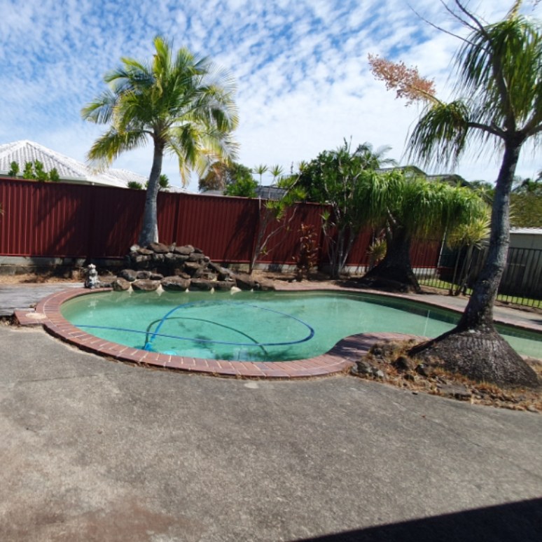 Pool edge cleared of grass and weeds